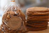 A clear plastic bag filled with cookie crumbs, with a label that reads 'heathcote bakery'.
